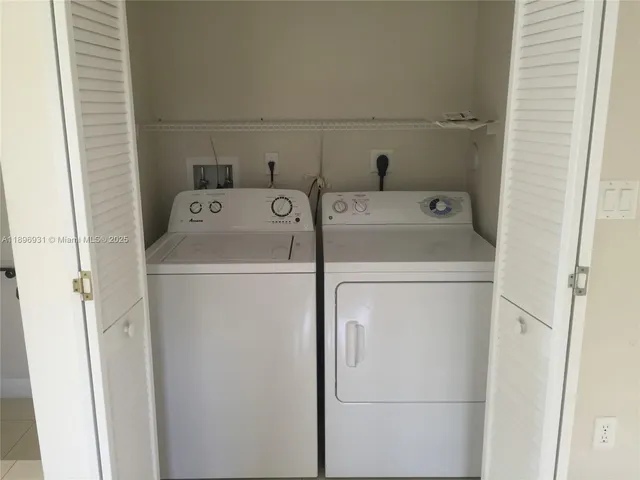 a view of water heater room with closet