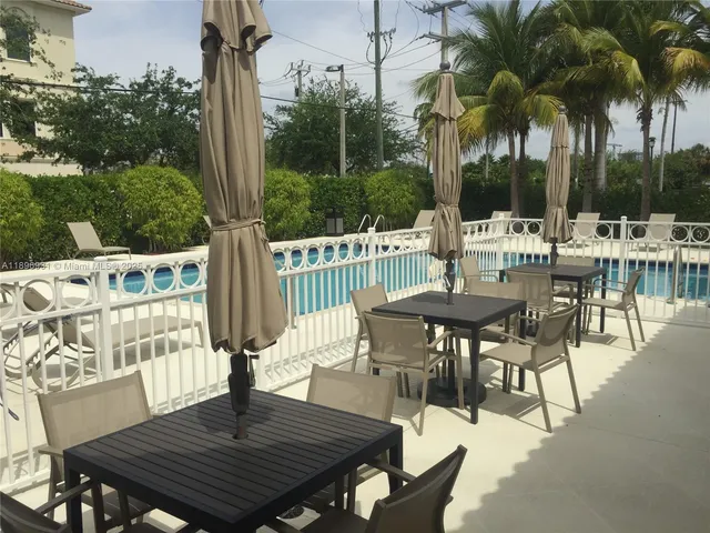 a view of backyard with swimming pool and outdoor seating