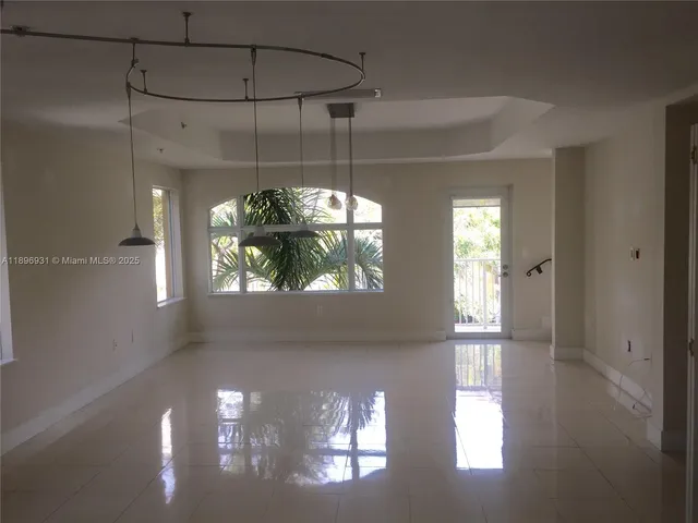 a view of a chandelier fan and entryway