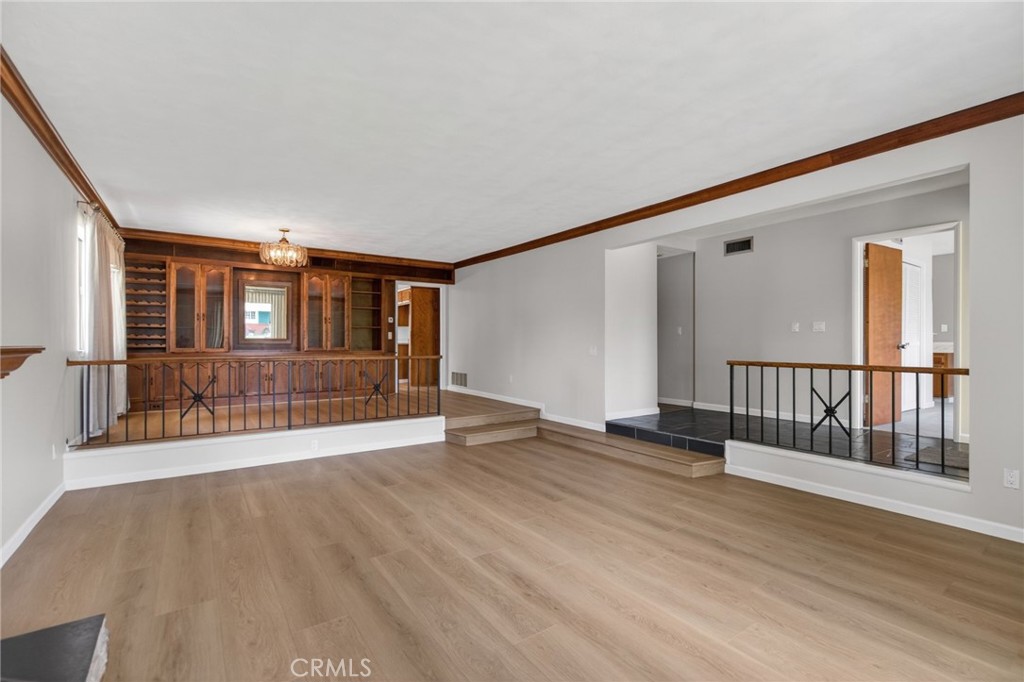 4963 Carlingford Avenue Riverside, CA 92504 - Photo 4 of 33 a view of an empty room with wooden floor and furniture