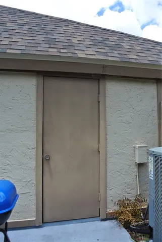 a view of a house with wooden wall roof and stairs