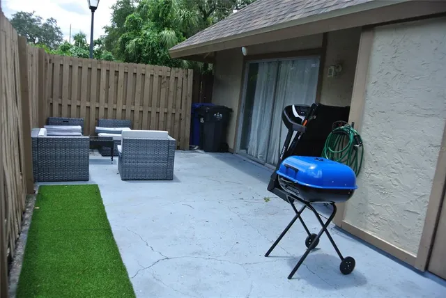 a patio with table and chairs