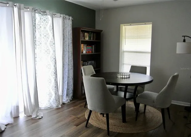 a view of a workspace with furniture and a window