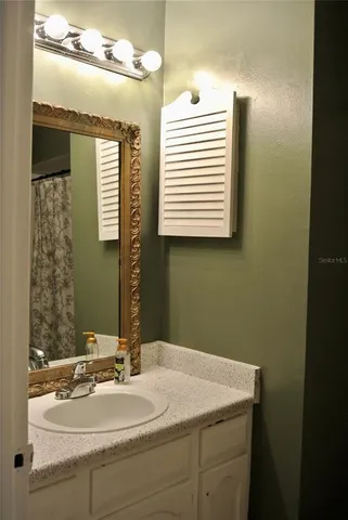a white toilet sitting next to a bathroom sink