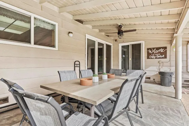 a view of house with swimming pool outdoor seating