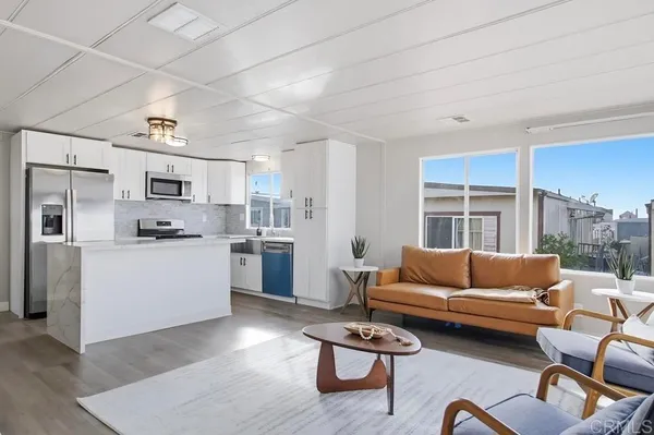 a living room with furniture flat screen tv and outdoor view