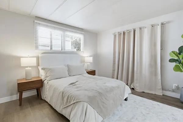 a bedroom with a bed and a window