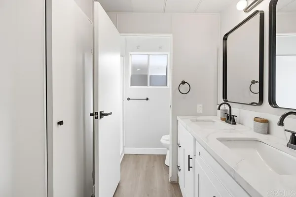 a bathroom with a sink a toilet and a mirror