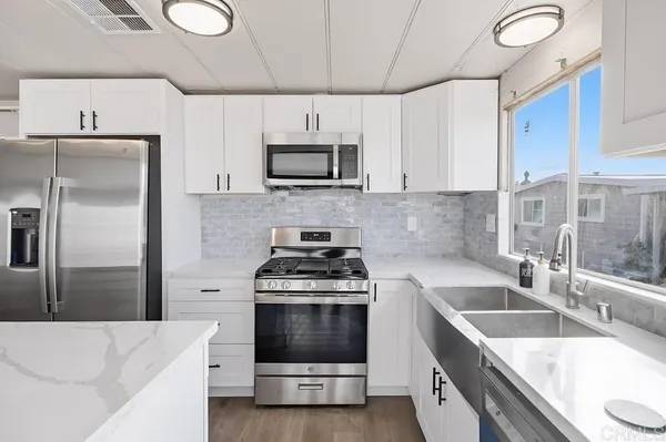 a kitchen with a sink stove and refrigerator