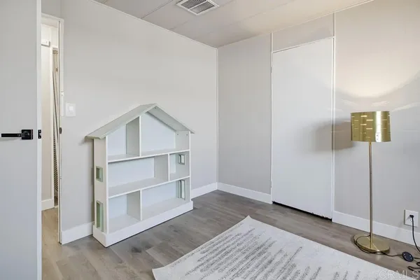 a view of a room with wooden floor
