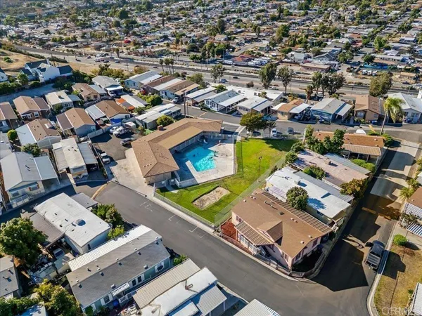 an aerial view of a residential apartment building with parking