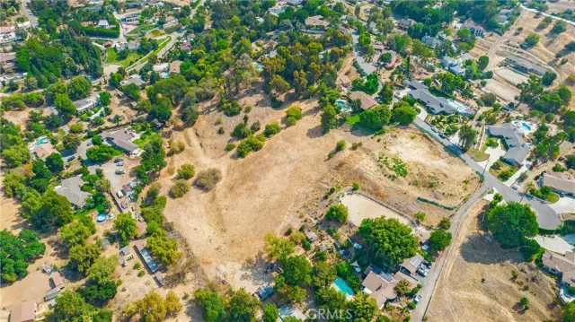 an aerial view of residential houses with yard