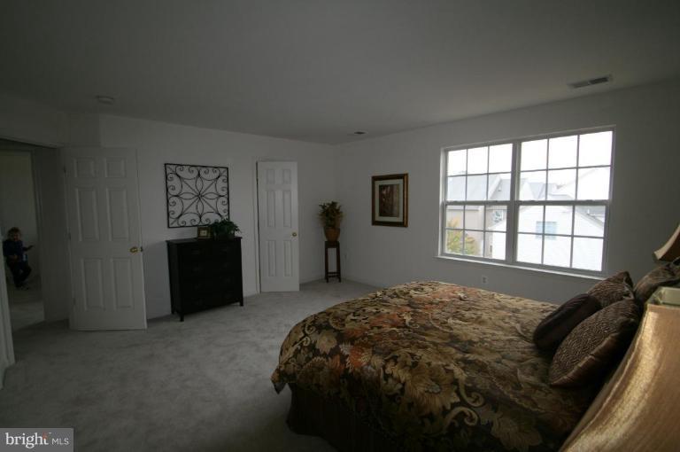 18107 Coachmans Road Germantown, MD 20874 - Photo 11 of 21 a bed sitting in a bedroom next to a window