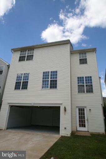 18107 Coachmans Road Germantown, MD 20874 - Photo 14 of 21 a front view of a house with a garden