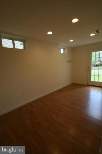 18107 Coachmans Road Germantown, MD 20874 - Photo 15 of 21 an empty room with wooden floor and windows