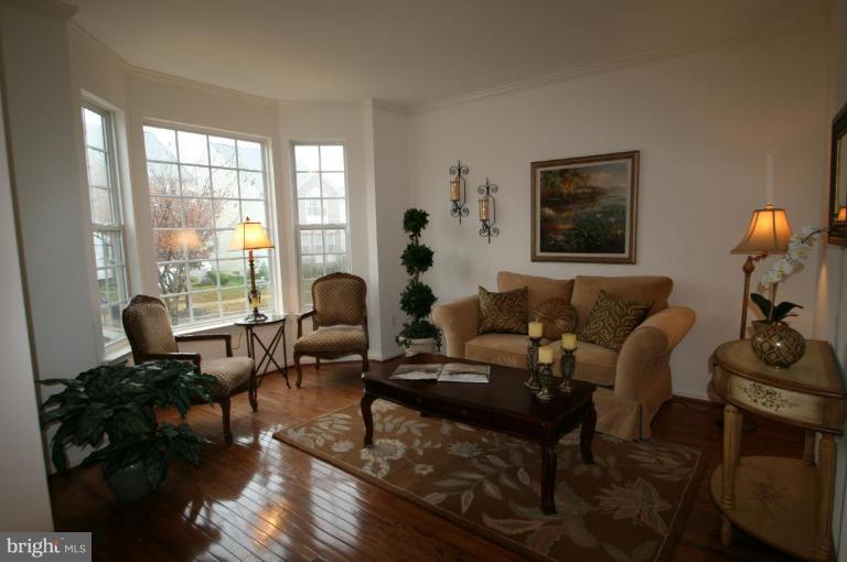 18107 Coachmans Road Germantown, MD 20874 - Photo 18 of 21 a living room with furniture and wooden floor