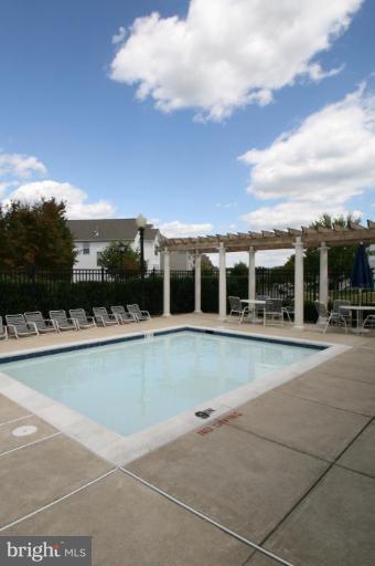 18107 Coachmans Road Germantown, MD 20874 - Photo 20 of 21 a view of swimming pool with lawn chairs