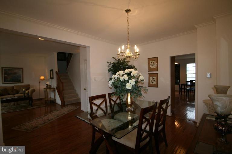 18107 Coachmans Road Germantown, MD 20874 - Photo 4 of 21 a view of a dining room with furniture and chandelier