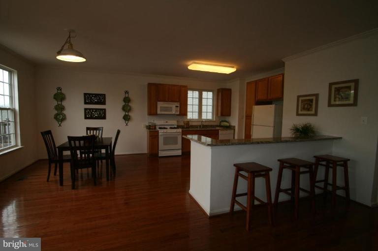 18107 Coachmans Road Germantown, MD 20874 - Photo 6 of 21 a view of a dining room with furniture and wooden floor