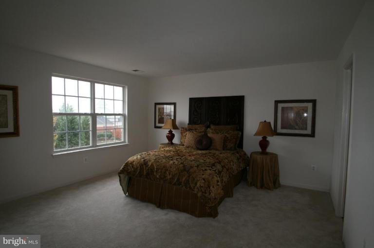 18107 Coachmans Road Germantown, MD 20874 - Photo 8 of 21 a living room with a bed furniture and a window