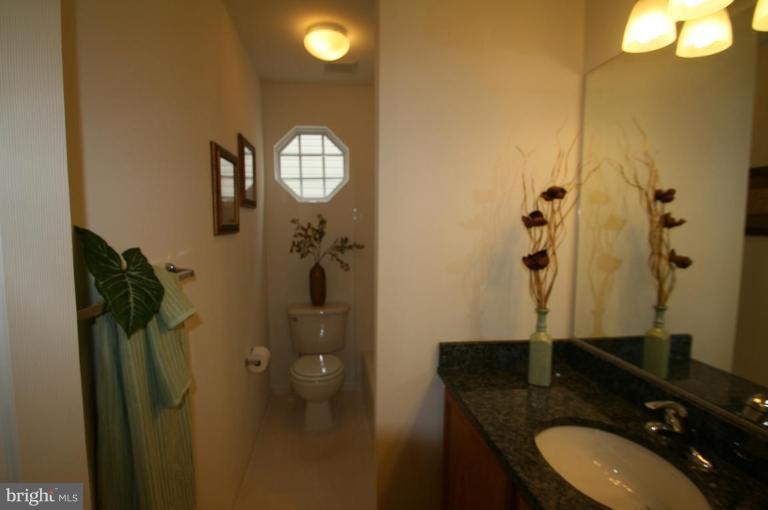 18107 Coachmans Road Germantown, MD 20874 - Photo 9 of 21 a bathroom with a toilet sink and mirror