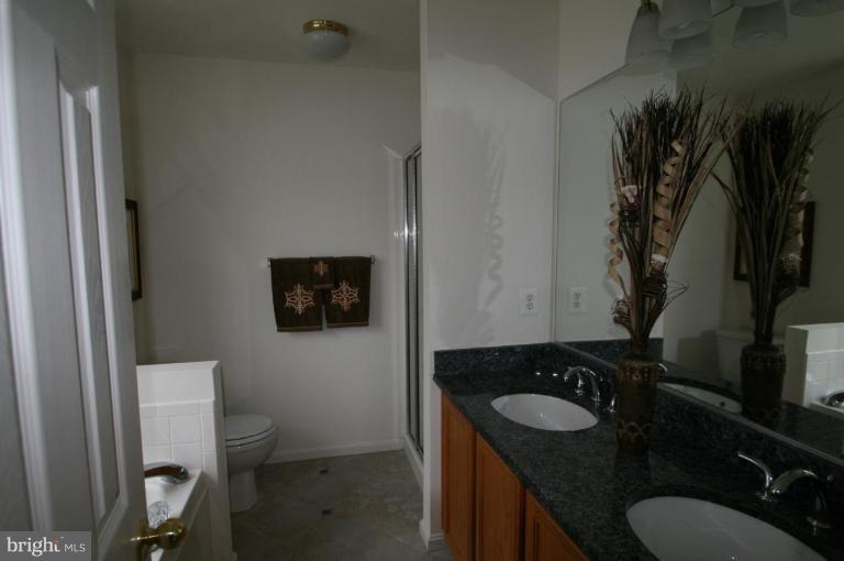 18107 Coachmans Road Germantown, MD 20874 - Photo 10 of 21 a bathroom with a granite countertop sink and a toilet