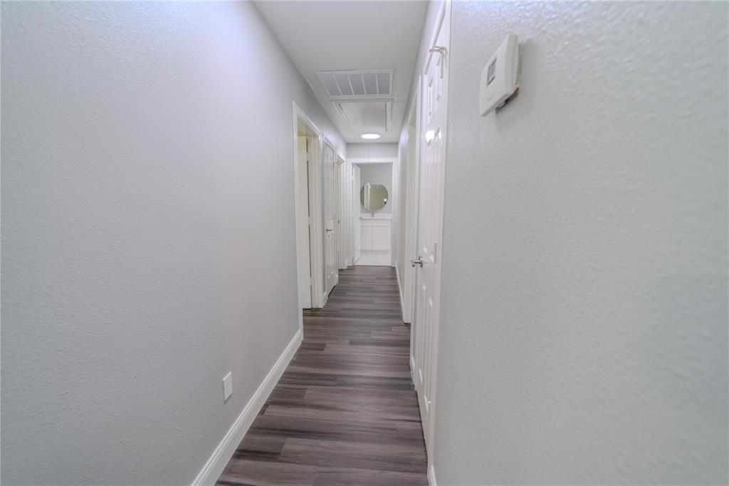 809 Wilcox Street McKinney, TX 75069 - Photo 11 of 26 Corridor with a textured wall and dark wood-style floors