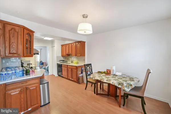 a kitchen with a table chairs a sink dishwasher window and cabinets