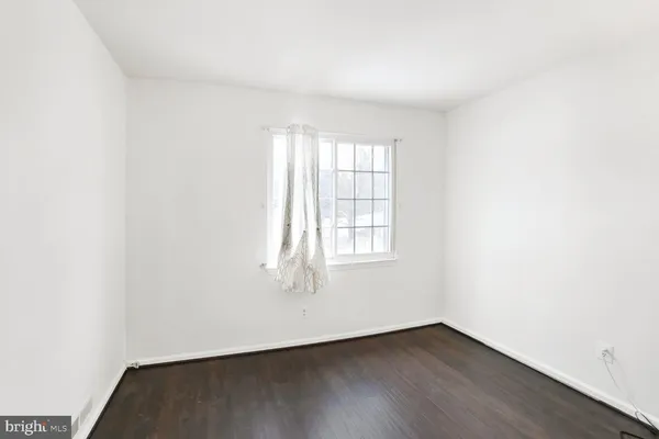 a bedroom with a large bed and flat tv screen on a dresser
