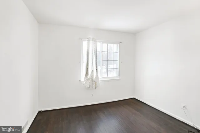 a bedroom with a large bed and flat tv screen on a dresser