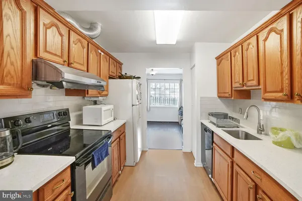 a kitchen with stainless steel appliances granite countertop a stove and a sink