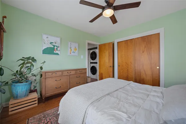 a bedroom with a bed dresser and a window