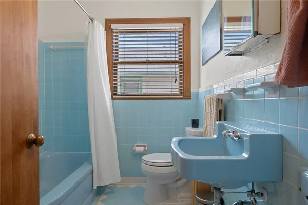 a bathroom with a sink a toilet and tub