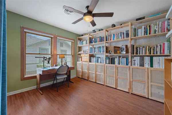a living room with furniture and a book shelf