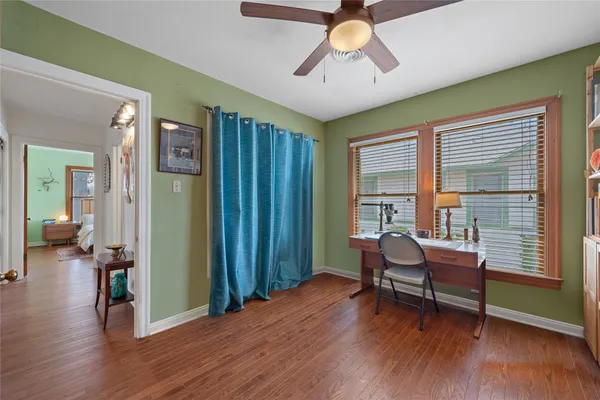 a living room with furniture and a wooden floor