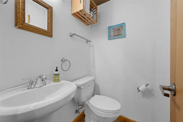 a white toilet sitting next to a bathroom sink