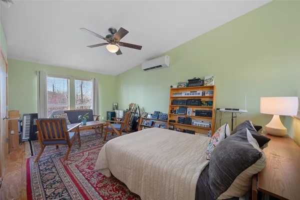 a bedroom with bed and a chandelier