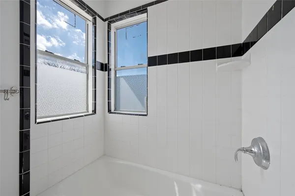 a bathroom with a shower and a sink