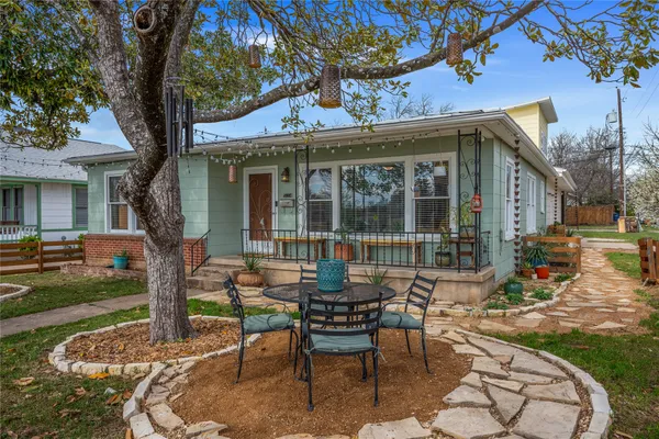 a view of a house with backyard sitting area and garden