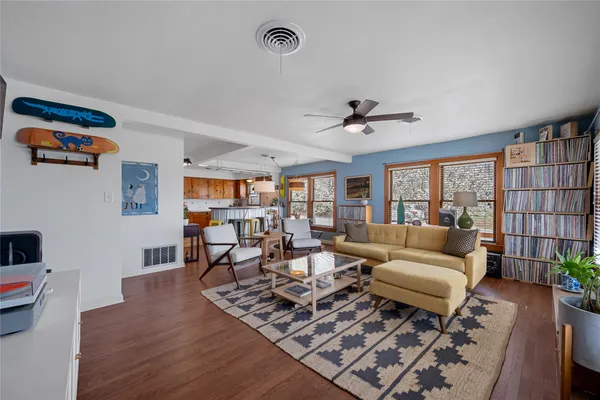 a living room with furniture and a wooden floor