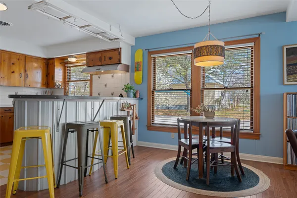 a dining room with furniture and wooden floor
