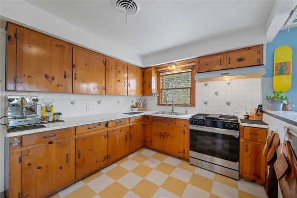 a kitchen with stainless steel appliances a stove a sink and a refrigerator