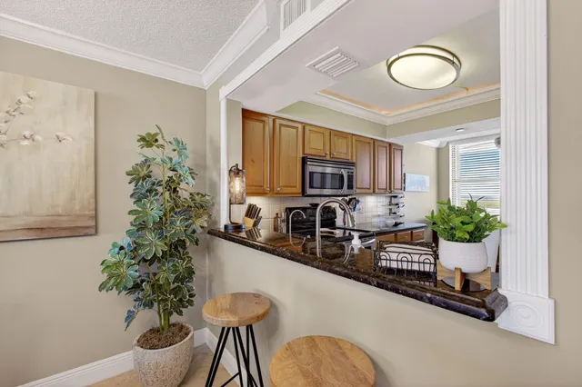 a kitchen with stainless steel appliances a microwave a stove and cabinets