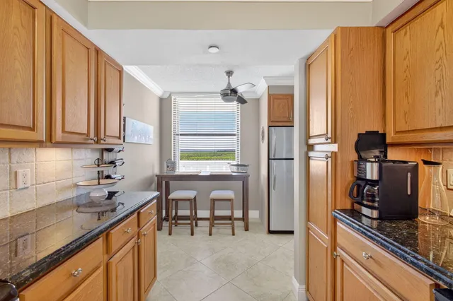 a kitchen with stainless steel appliances a sink cabinets and a window