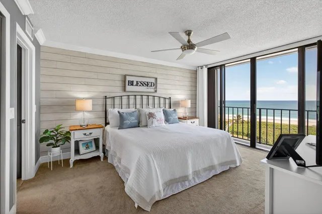 a spacious bedroom with a bed and a large window