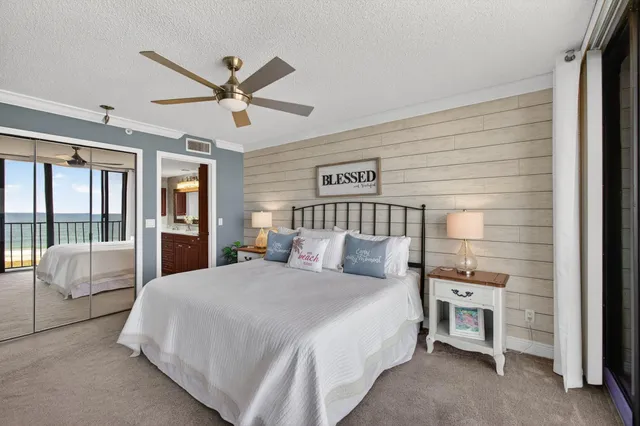 a spacious bedroom with a bed and large window