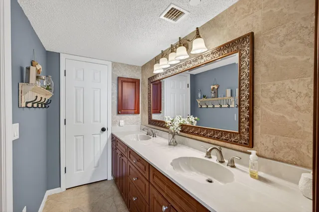a bathroom with a double vanity sink and a mirror