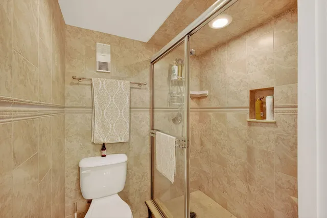 a bathroom with a toilet sink and shower