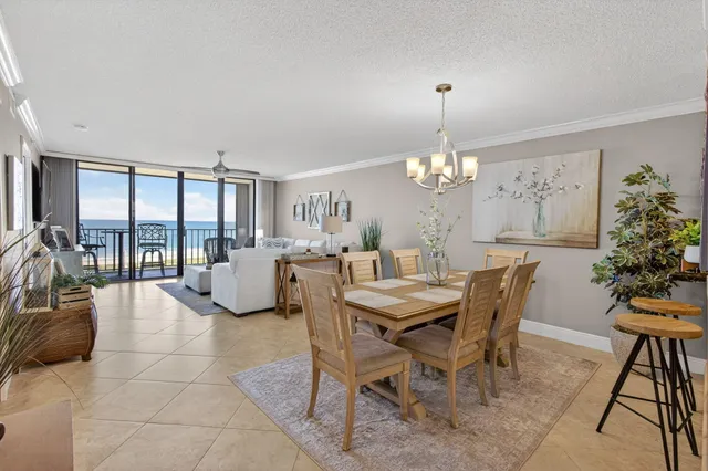 a view of a dining room with furniture and chandelier