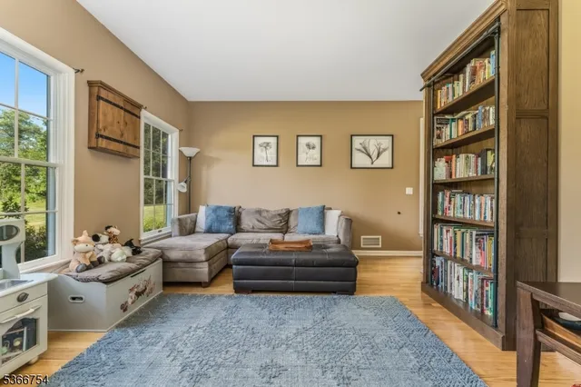 a living room with furniture and a book shelf